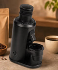Electric Coffee Grinder With 80Mm Flat Burrs And Stepless Dial For Espresso Pour Over Drip Coffee French Press And Cold Brew 70G Hopper Adjustable Speed Crushes Beans Dead On Consistent Daily placed near coffee cup and beans.