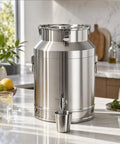 Tough As Nails Heavy Duty Stainless Steel Water Dispenser Milk Can Jug With Secure Locking Airtight Lid placed on table with glass.
