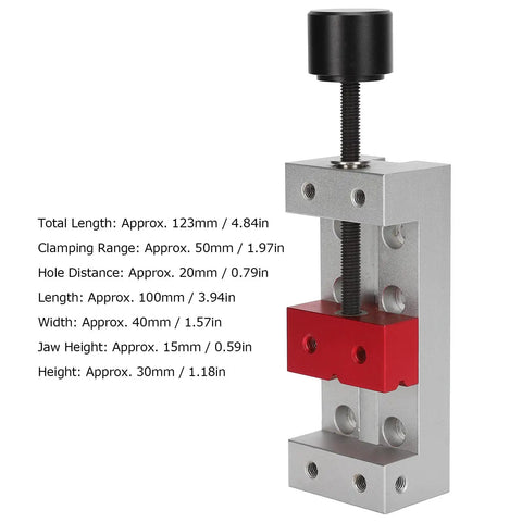 Compact Aluminum Mini Bench Vise For Woodworking Hobbyists, A Handy Little Table Clamp With 50mm Jaw Range, 123mm Overall Length, 20mm Mount Hole Distance, Ideal For Engraving, Drilling, And Small Repairs. Silver mini bench vise with red jaw block and black screw handle.