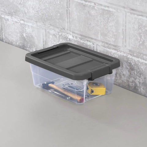 Six Pack 16 Quart Stackable Storage Bins With Snap Tight Lids And Non Slip Base Mats Dark Gray Clear Plastic Heavy Duty Organizers For Home Garage And Closets Built Tough No Fuss Setup Rock Solid Gear on a table holding tools.