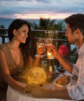 Couple dining with a Levitating Moon Lamp With Hovering Glow, Rotates In Air, LED Table Night Light, sunset view