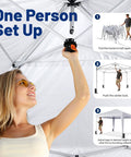 Easy Up 10x10 Pop Up Canopy With Sidewalls One Push Instant Setup showing one person setting up the frame and locking mechanism.
