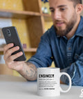 Man holding phone with Engineer Definition Funny Gift Mug For Engineering Students Teachers And Pros 11 Oz White Ceramic