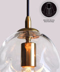 Close-up of Dope Clear Art Glass Pendant Lights 2 Pack for Kitchen Island showing brass hardware and adjustable lamp head design.
