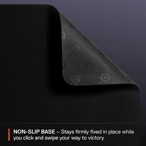 Close-up of QcK Large Gaming Mousepad with non-slip silicone rubber base and pro-grade surface for gaming sensors.