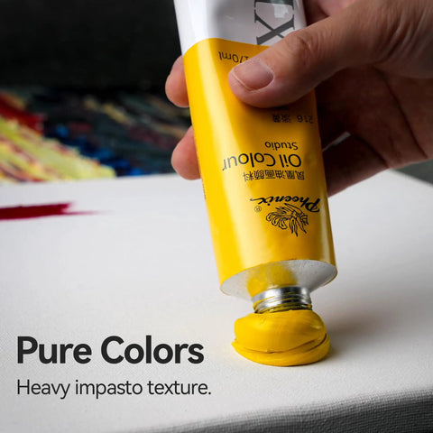 Hand squeezing yellow oil paint from tube onto canvas, demonstrating impasto technique.