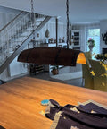 Rustic Resin Wine Barrel Pendant Lamp With Tree Grain Pattern illuminating a cozy farmhouse kitchen area, E26 socket.