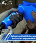 Gloved hands using Beefy Pro Grade Multi Piston Brake Caliper Compression Tool For Cars And Trucks Heavy Duty Caliper Press.
