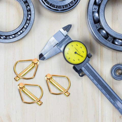 Heavy Duty Linch Pin Lock Shaft Fastener Secures Tractor Trailer Axles With Reliable Spring Loaded Action Made From Durable Carbon Steel And Golden Finish For Industrial Jobs And Heavy Work displayed with caliper and bearings.