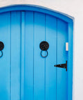Blue wooden door with Heavy Duty Iron Door Hinges 4 Inch Extended T Shape Slotted Bearing Hinges, black finish, installed.