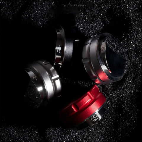 Legit Espresso Coffee Distributor Tamper For 57mm And 57.5mm Portafilters in matte black, silver, and red colors on dark surface.