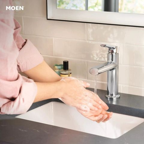 Person washing hands under Meena Chrome One-Handle Bathroom Sink Faucet With Single Hole Mount And Optional Deckplate Drain Assembly Slick