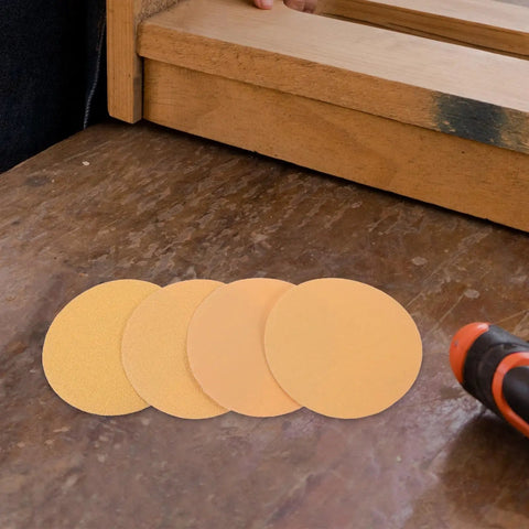 Kickstart Your Rust Removal With This 40 Pc Sanding Disc Grit Set Featuring 120 220 and 400 self adhesive varieties on a wooden surface.