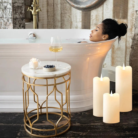 Ivory Flickering Flameless Candles With 3D Moving Flame 1000 Plus Hours Battery Operated Pillar Candles beside a bathtub