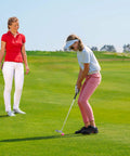 Teen playing golf with Right Hand Golf Putter For Beginners And Teens, 33 Inch Mini Golf Set, instructor watches on a course.
