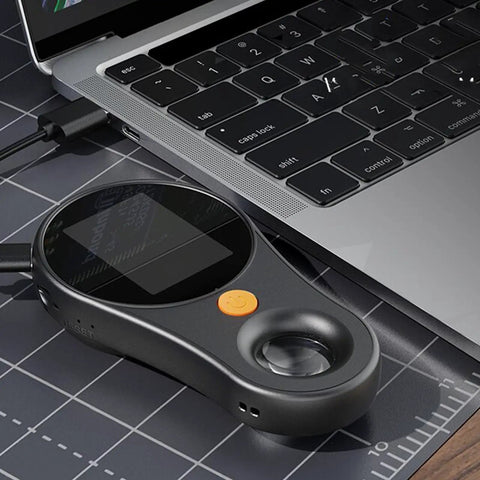 Pocket Size Handheld Digital Microscope With 1080P HD And 500X Magnification, 2MP Lens, 2.0 Inch Screen, 8 LED Lights, USB C Cable, Great For Kids And Adults To Explore Insects And Plant Details On The Go. Black handheld digital microscope beside a laptop