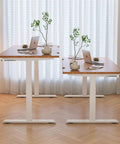 Get Your Posture Locked In With This Cherry Wood Manual Standing Desk And Straight Up Game Changing Crank Lift Mechanism For Home Offices Or Bedrooms Boasting A Foldable Handle And Massive Work Surface, showcasing double desks and plants.
