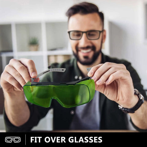Heavy Duty Laser Safety Glasses Delivering Straight Up Optical Density Blocking For Blue Violet And Infrared Lasers Dual Band Industrial Eyewear shown in hands of a smiling man.