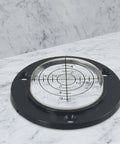 Micpointik 50x12mm Circular Bubble Level on marble surface, black base with clear circular vial and measurement markings.