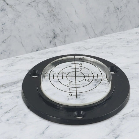 Micpointik 50x12mm Circular Bubble Level on marble surface, black base with clear circular vial and measurement markings.