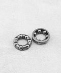 Close-up of metal 4 Pack Bike Ball Bearing Retainer Cage With 7 Balls for front wheel bearing bracket and bicycle repair accessory.