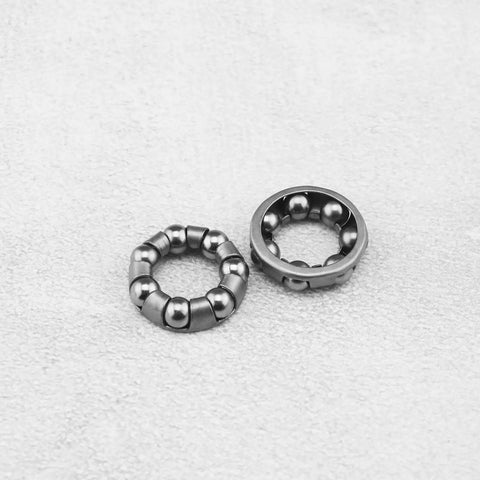 Close-up of metal 4 Pack Bike Ball Bearing Retainer Cage With 7 Balls for front wheel bearing bracket and bicycle repair accessory.