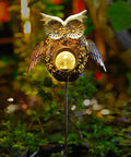 Solar Owl Garden Stake Lights For Lawn And Pathway, bronze crackled glass owl glowing in garden at night, rustproof metal