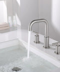 8 Inch Brushed Nickel Widespread Bathroom Faucet With Two Handles, 3 Hole Mount, SpotShield Finish mounted on white sink