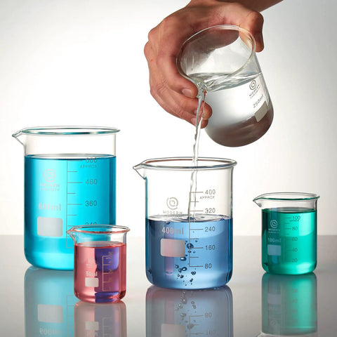 Rock Solid Borosilicate Glass Beaker Set That Works Like A Charm For Chemistry Class College Lab Research And Personal Science Projects Featuring Clear Graduations And Easy Pouring In This Heavy Duty Four Piece Six Hundred Milliliter Pack with colorful liquids in various sizes.