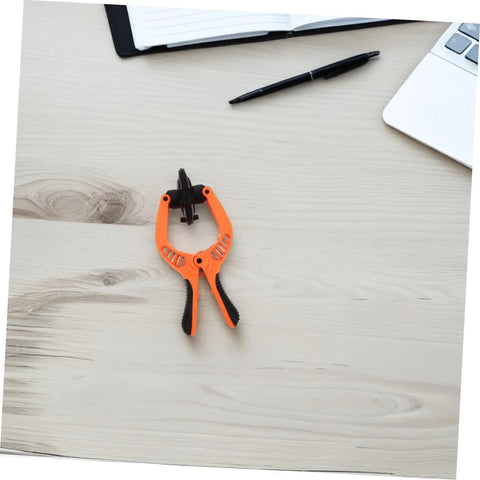 Mobile Phone Screen Opening Tool With Cup And Pliers For Quick Repairs Pro Grade LCD Removal Kit on a wooden desk with laptop and pen.