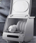 Beat The Dirty Dish Rut With This Slick Portable Dishwasher, Smart Mini Countertop Automatic Model In Stainless Steel, Quick Setup Saves Counter Space And Scrubs Dishes Spotless Every Single Day, open with dishes loaded.