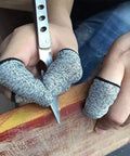 Person wearing cut-resistant finger cots while carving wood, highlighting 12 Piece Finger Cots Set Cut Resistant Protectors, Non Slip HPPE Fabric Finger Covers For Kitchen, Cooking, Work, Sculpture, DIY, Art, And Crafts, Breathable, Reusable, Easy To Clean, Grip Ready.
