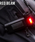 Magnetic LED Clip Light With Dual Color White And Red Beams, 80 Lumen, attached emitting red light on black fabric.