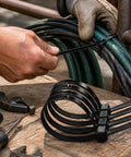 Heavy Duty Self Locking Nylon Cable Ties In Black used to secure multiple cables on a workbench, showcasing tough performance.