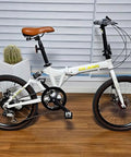 Folding bike with 52T Aluminum Beefy Single Speed Crankset, 170mm arm, and 130mm BCD chainring guard, sand black finish.