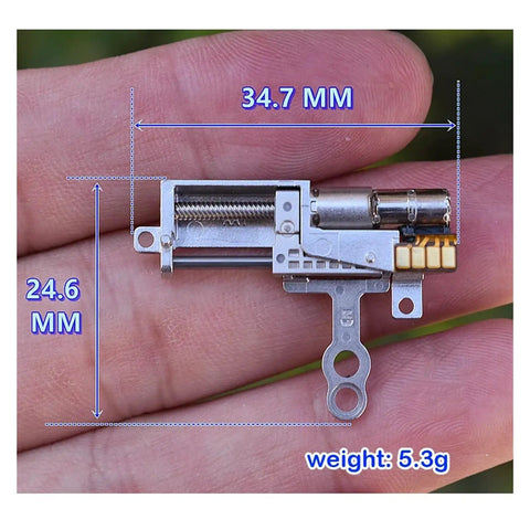 11.5mm Stroke Linear Actuator with 5mm Precision Planetary Gearbox held on palm, showing dimensions 34.7mm by 24.6mm, weight 5.3g