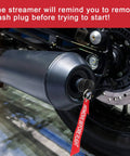 Close-up of exhaust wash plug in motorcycle, labeled 'REMOVE BEFORE FLIGHT'. Exhaust Wash Plug For Motorcycles And Dirt Bikes 0.6 To 1.5 Inch Thick Rubber Fits 2 Stroke Exhaust Ports Keeps Water Dirt And Rodents Out When Washing Or Storing Your Ride Pack Of 2.