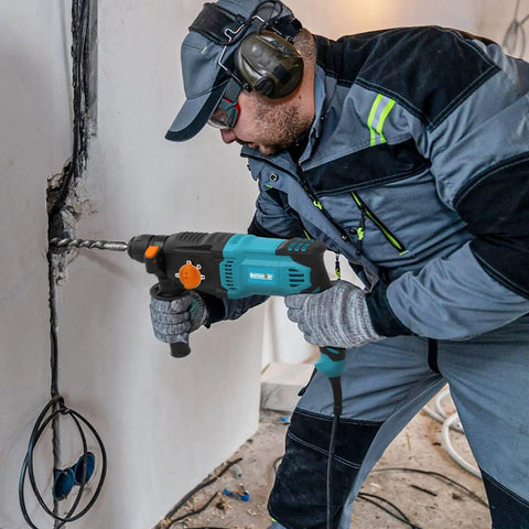 Man using One Inch SDS Plus Rotary Hammer Drill With Safety Clutch 7 Amp Corded 4 Function Variable Speed for drilling wall