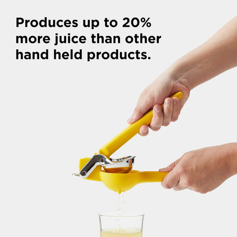 Hands using No Fuss Lemon Squeezer Citrus Juicer With Dual Gear Power Manual Hand Press pouring juice into glass.