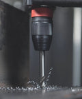 Close-up of 18V Cordless Driver Drill Kit Handles Heavy Demands With Two 18V 5.5Ah Batteries and drill bit in metalwork.
