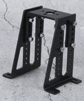 RC motor mounting bracket, black aluminum alloy frame with perforated arms and bolts (front view).