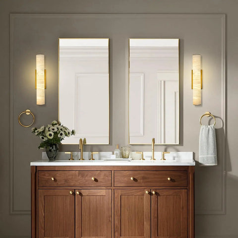 Brushed Brass And Natural Alabaster Wall Sconces Set Of Two casts a super chill ambient glow over modern bathroom sink.