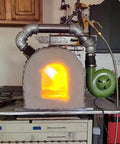 Variable Speed 110V 240CFM Forge Blower Fan With Airflow Controller in operation on a metal forge setup for blacksmithing