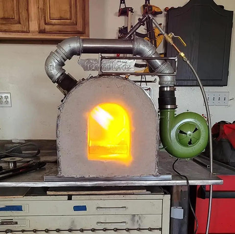 Variable Speed 110V 240CFM Forge Blower Fan With Airflow Controller in operation on a metal forge setup for blacksmithing