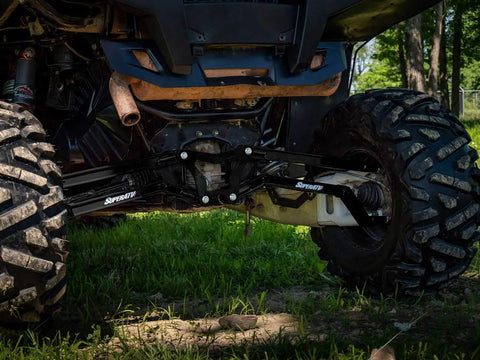 High Clearance Boxed Rear Radius Arms Beefed Up For Polaris RZR XP 900 And XP 4 900 2011 To 2014 Black Finish Heavy Duty Welded Strength Upgrade For Tough Trails And More Maneuverability. Rear view under UTV on trail