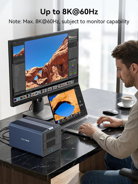 Person editing on laptop next to Ultimate 4 Bay Hybrid Raid Enclosure For 3.5 And 2.5 Inch Sata Drives Plus Dual Nvme Ssd Bays Usb4 Thunderbolt 5 Ready Plug And Play Desktop Dock.