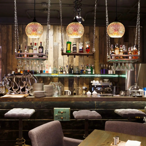 Set of 3 Modern Glass Pendant Lights With Colorful 3D Firework Design illuminating a stylish bar area.