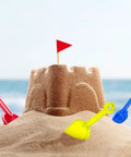 12 Piece Colorful Beach Sand Shovels For Kids Set With Plastic Summer Scoops digging around a sandcastle on a beach