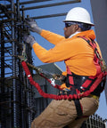 Construction worker wearing EagleLite Three D Ring Harness With Tongue Buckles Heavy Duty Polyester Nylon Large Size for fall protection.