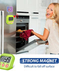 Woman placing tray in oven, using Set Of 30 Multicolor Digital Kitchen Timers With Magnetic Mount Loud Alarm And Big Digits Countdown To 99 Minutes 59 Seconds Lit on fridge.